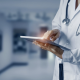 Doctor holding a tablet and interacting with it.